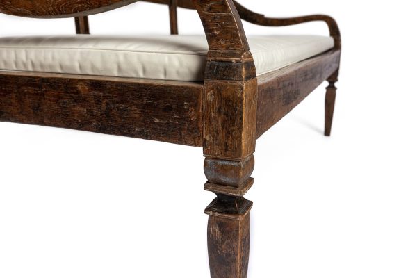 Wood Bench with carved back and white cushion - angled view